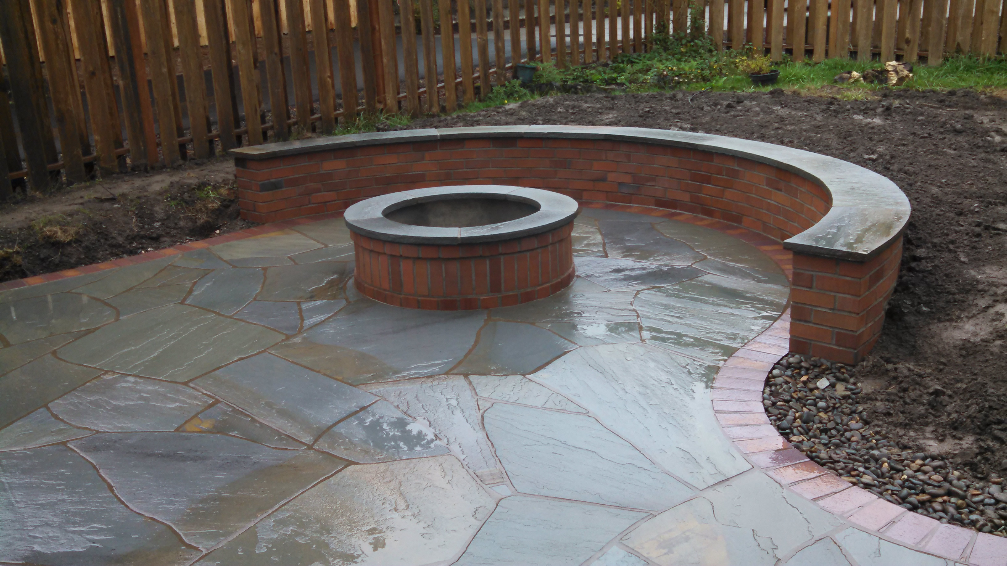 Bluestone patio with brick and stone firepit and seating